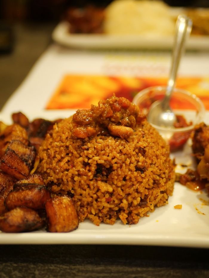 pexels photo 17952745 17952745 A tempting plate of Jollof rice accompanied by savory fried plantains. Perfect meal idea.